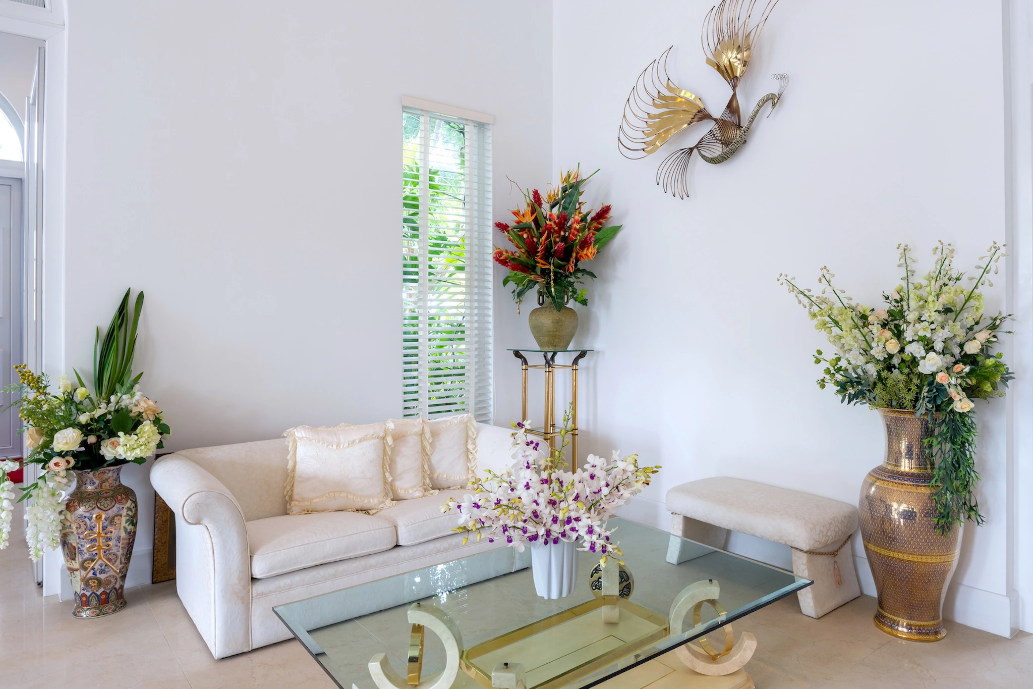 Bright sitting area with a white sofa and garden-facing windows